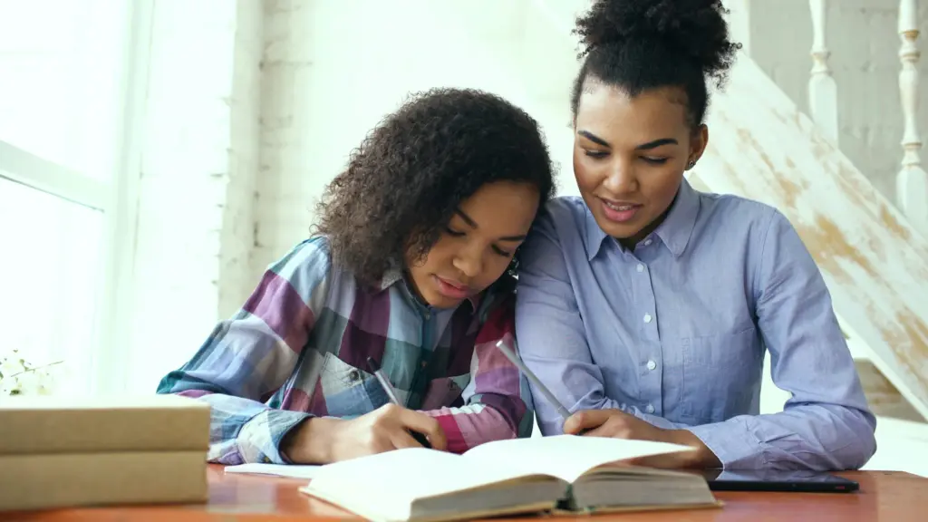 Parent and teen working together at a table