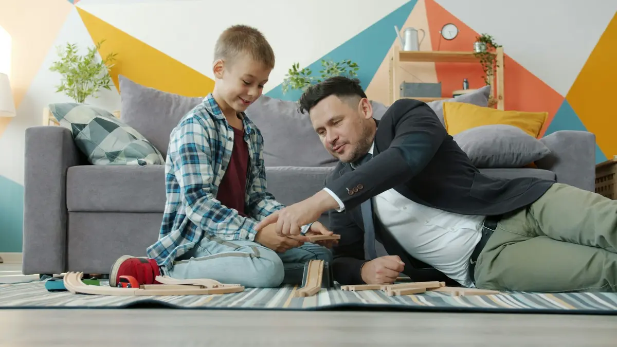 Adult and child sorting belongings together in a living room
