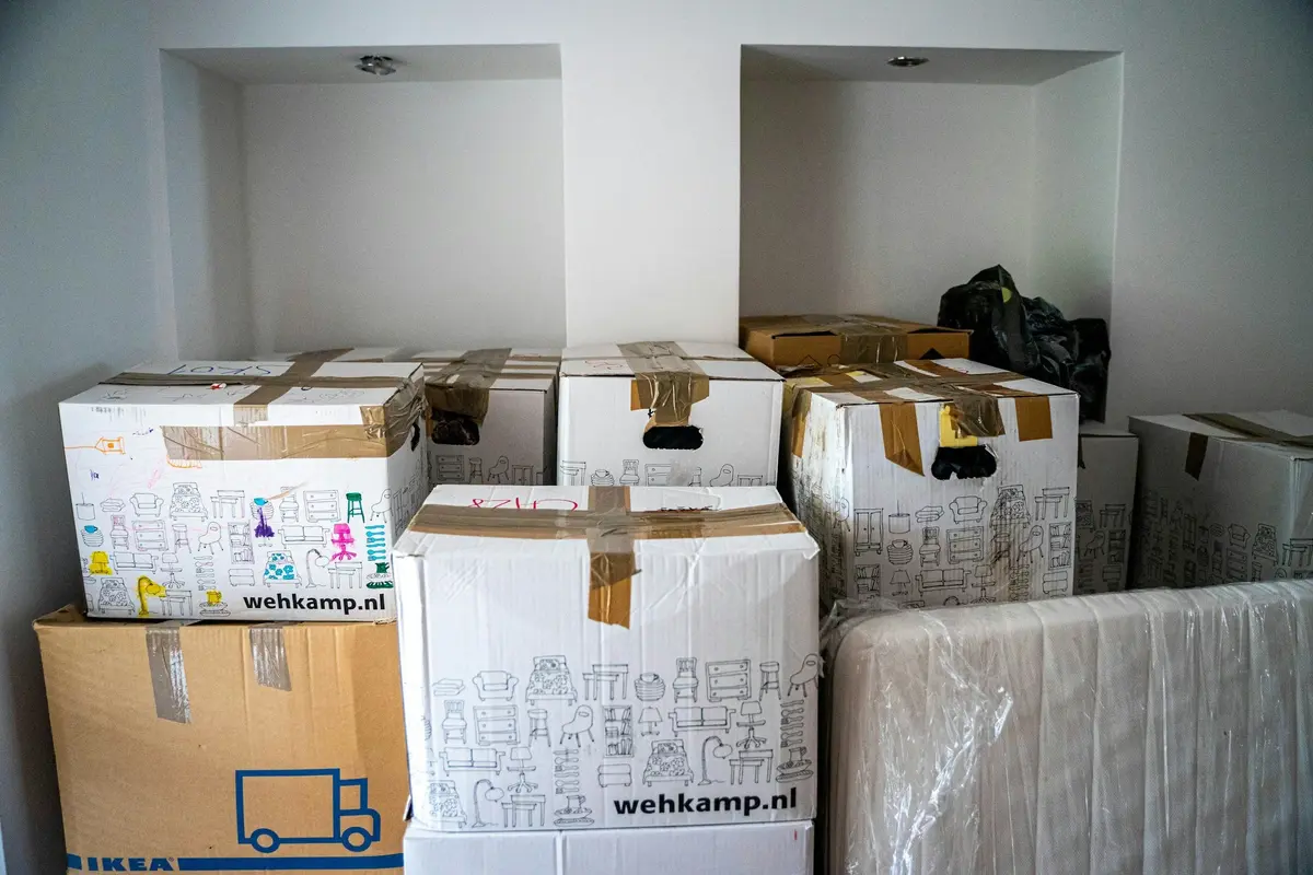Cardboard moving boxes stacked in an empty room
