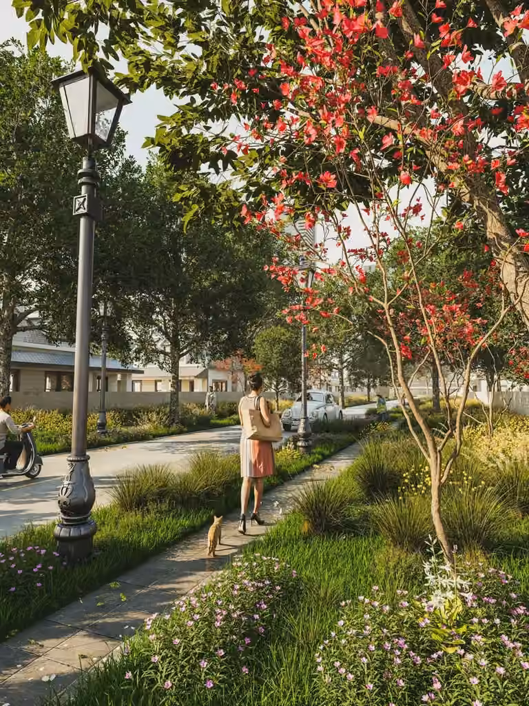 Flowering trees beside a lamppost on a walking path
