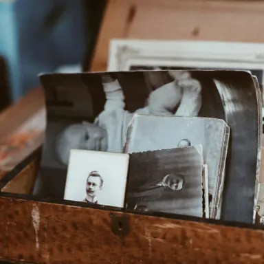 A collection of old family photographs in a box