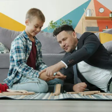 Adult and child sorting belongings together in a living room