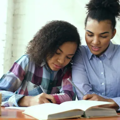 Parent and teen working together at a table
